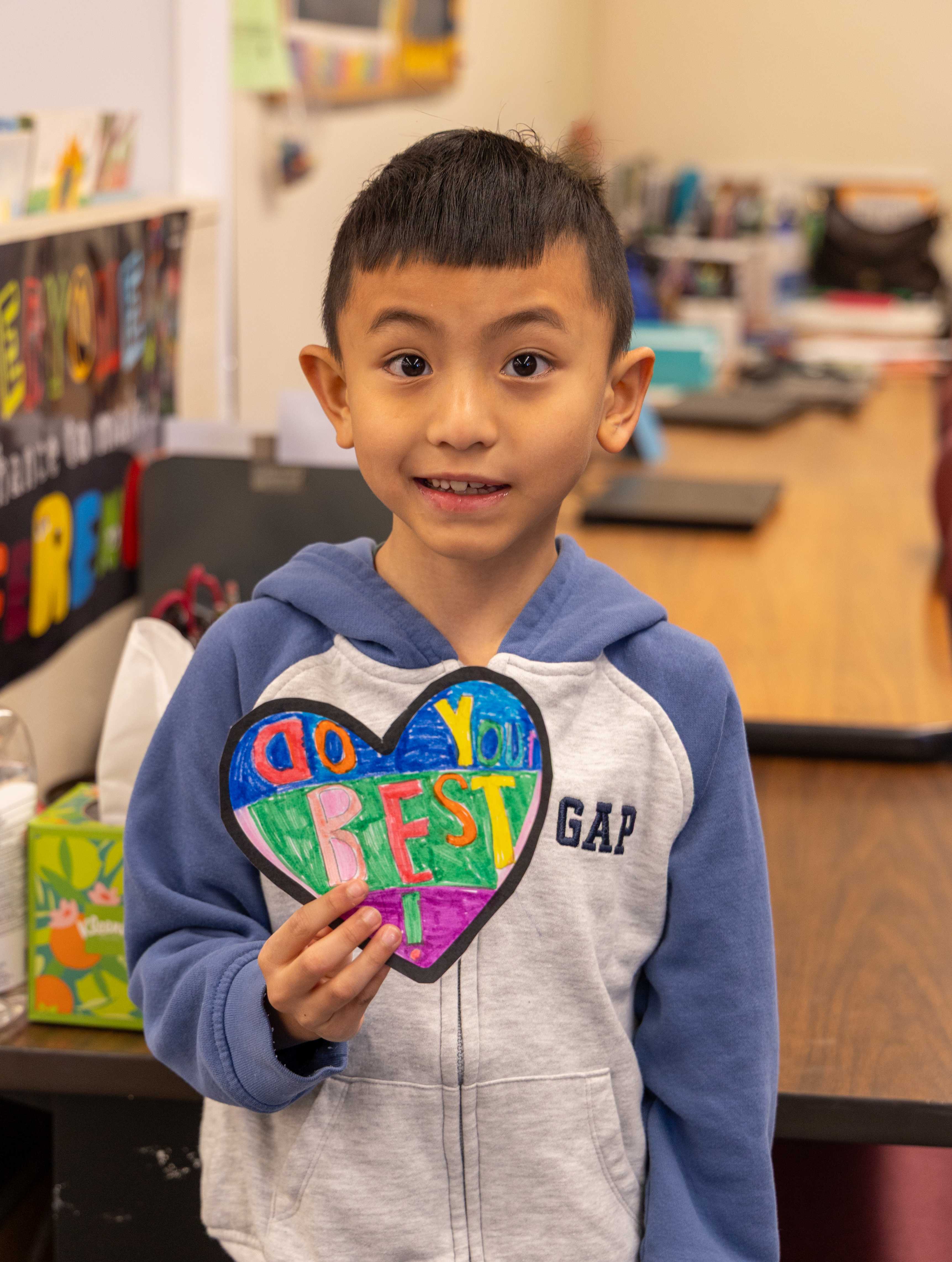 A student holds a designed heart